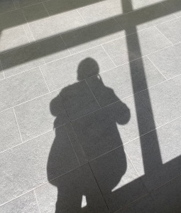 Shadow of a window frame and a person